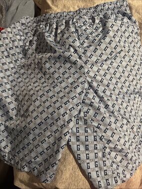 Gucci Men's White and Navy Interlocking G Swim Trunks.